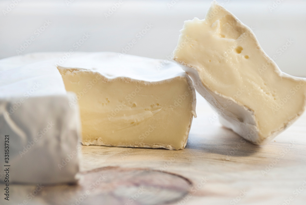 Camembert cheese, brie. On a wooden background. Cheese without lactose.