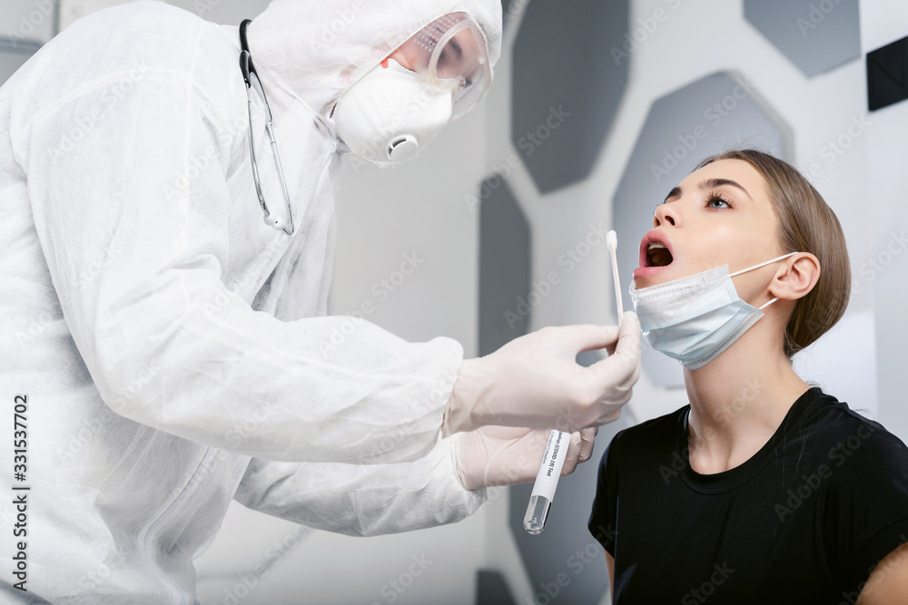 Doctor epidemiologist virologist takes a sample of biological material for analysis on coronavirus. Pandemic Covid-19.