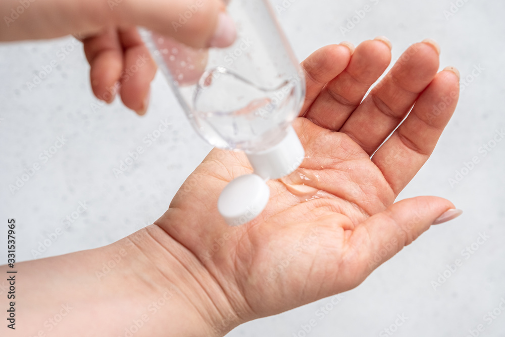 Hand cleaning gel. Pouring sanitising hand gel onto a woman hand Hand cleaning gel. Pouring sanitising hand gel onto a woman hand