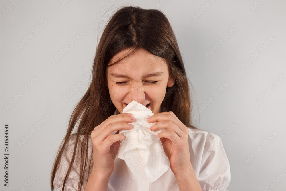 Sick kid caughing and blowing nose into paper napkin. Virus infection spread, respiratory hygiene and allergy concept Sick kid caughing and blowing nose into paper napkin. Virus infection spread, respiratory hygiene and allergy concept