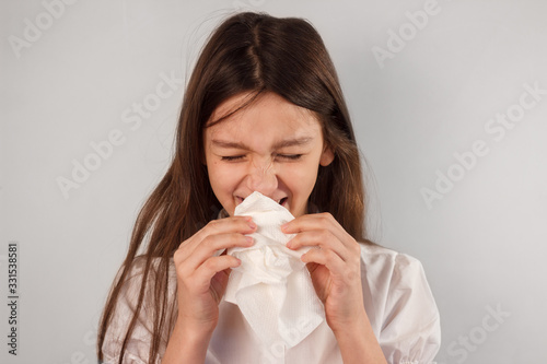 Sick kid caughing and blowing nose into paper napkin. Virus infection spread, respiratory hygiene and allergy concept