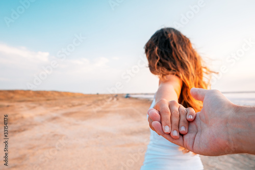 a girl goes on a sea holding a fellow on a hand