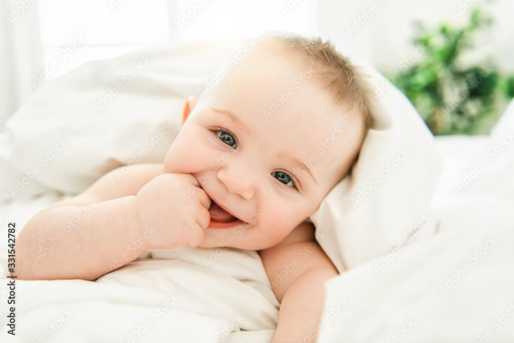 cute baby boy lying on a white bed cute baby boy lying on a white bed