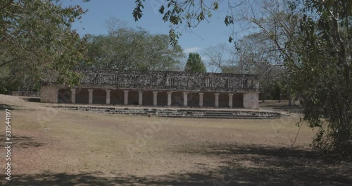 acercamiento con gimbal a unas ruinas con columnas en la ciudad maya de uxmal photo