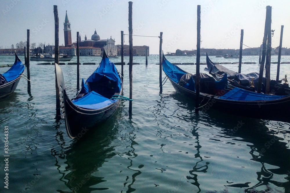 Venetian boats gondolas in harbor in Venice, Italy.