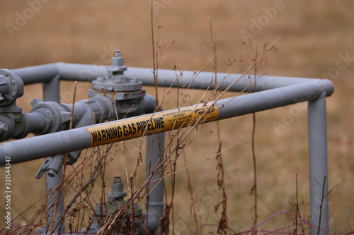 Barricade with caution tape protecting a natural gas pipeline regulating station