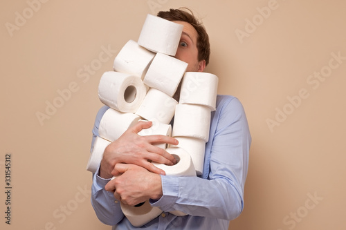 Caucasian man stocking up toilet paper at home photo