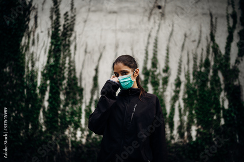 Scared sick woman wearing protective mask.Suffering from infectious disease.Infected patient suffering from symptoms of illness.Panic and fear of infection.Life in contaminated area.Nosophobia photo