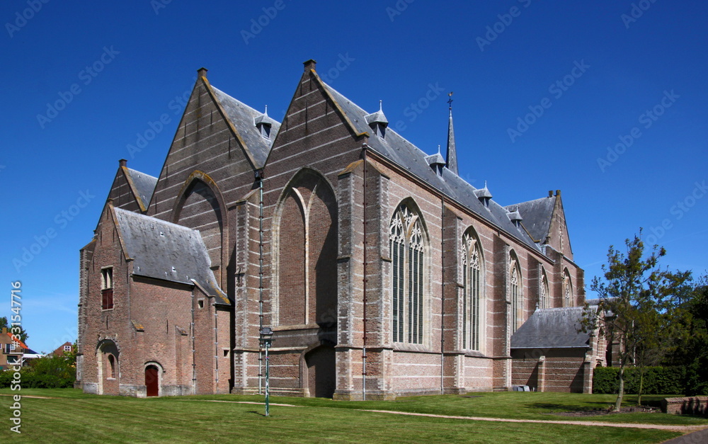 Backside of the late gothic hall church with its brick naves in Brouwershaven city in the Netherlands
