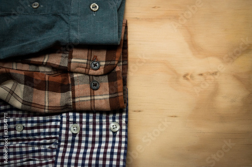 Plaid shirts on a wood surface