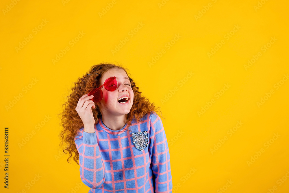 red haired , emotional girl with red glasses on a yellow background red haired , emotional girl with red glasses on a yellow background