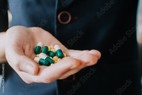 Medicine pills or capsules in hand. Pharmaceutical medicament. Antibiotic, painkiller closeup. Corona virus, COVID-19 OR 2019-nCov, the virus, concept for healthcare and medical.