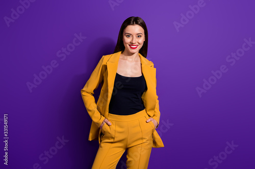 Portrait of pretty cool content girl put hands trousers relax rest on her luxury party stand copyspace isolated over purple color background