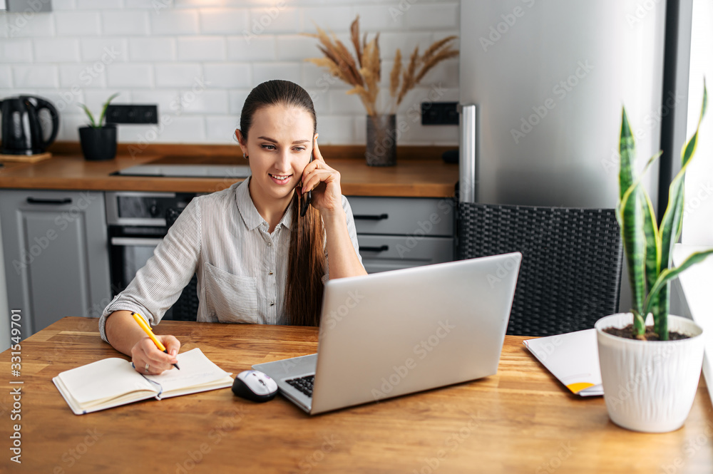 Young woman works from home using laptop. Young woman works from home using laptop.