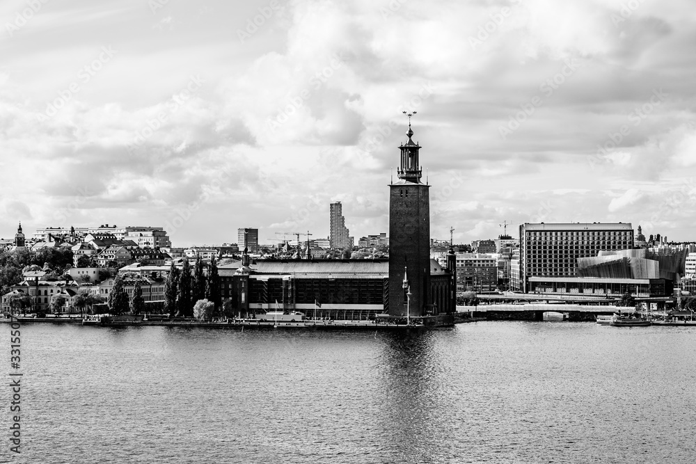 City hall on the waterfront of Lake Malaren as seen from Monteliusvagen hill in Stockholm, Sweden in black and white