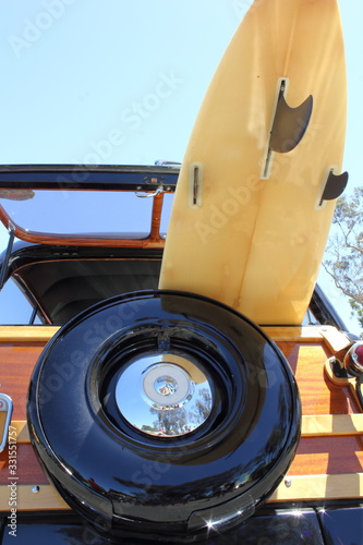 Woody  with a surfboard in back photo