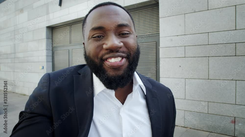 Businessman making video call on street. Freelancer talking on camera outdoors