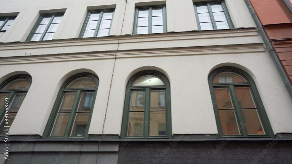 Steadicam shot: modern buildings in old european city. Facades of houses in narrow streets at Scandinavia. Traveling concept.