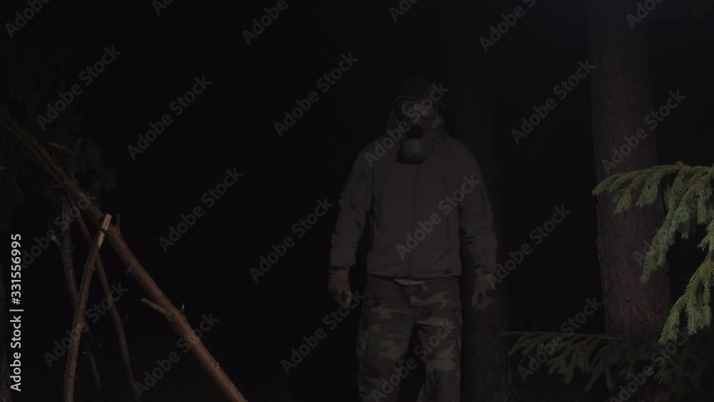 man in a gas mask escapes from coronavirus in the woods at night man in a gas mask escapes from coronavirus in the woods at night