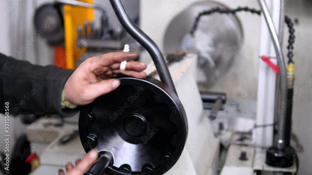 Mechanic using the hand wheel of old lathe milling machine. Conventional lathes designed for the highly efficient machining of workpieces in unit and serial production. Dolly shot of manual lathe Mechanic using the hand wheel of old lathe milling machine. Conventional lathes designed for the highly efficient machining of workpieces in unit and serial production. Dolly shot of manual lathe