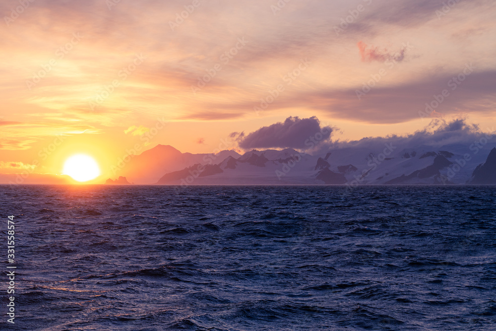 sunset over the sea in antarctica 