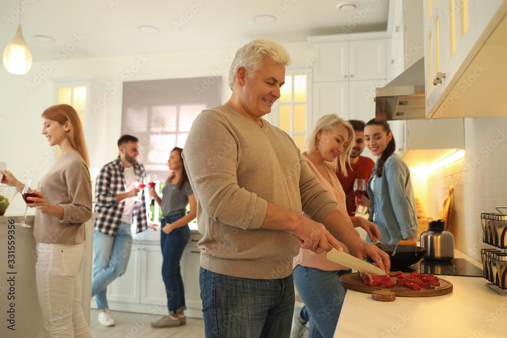 Obraz premium Happy people cooking food together in kitchen