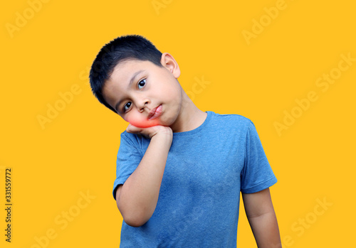 Little boy has toothache isolated on yellow background  with clipping path. © Janthana