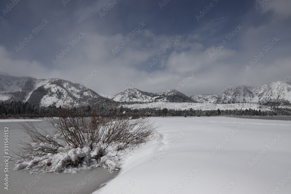 Fototapeta premium Snow and Ice at Kiva Beach and Taylor Creek Marsh Below Mount Tallac