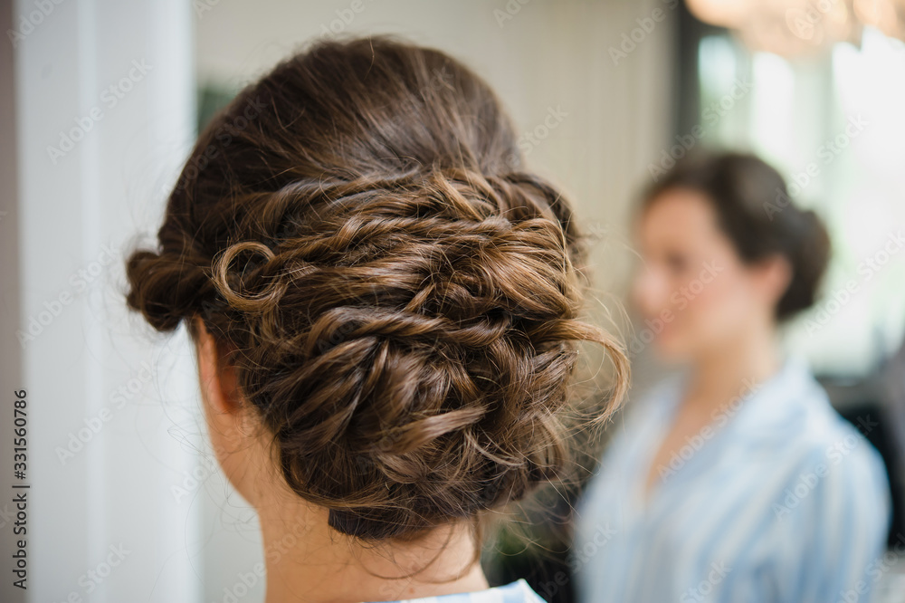 Beauty wedding hairstyle. Bride. Brunette girl with curly hair styling with barrette. Attractive young brunette woman with beautiful hairstyle with hair detail accessory Beauty wedding hairstyle. Bride. Brunette girl with curly hair styling with barrette. Attractive young brunette woman with beautiful hairstyle with hair detail accessory