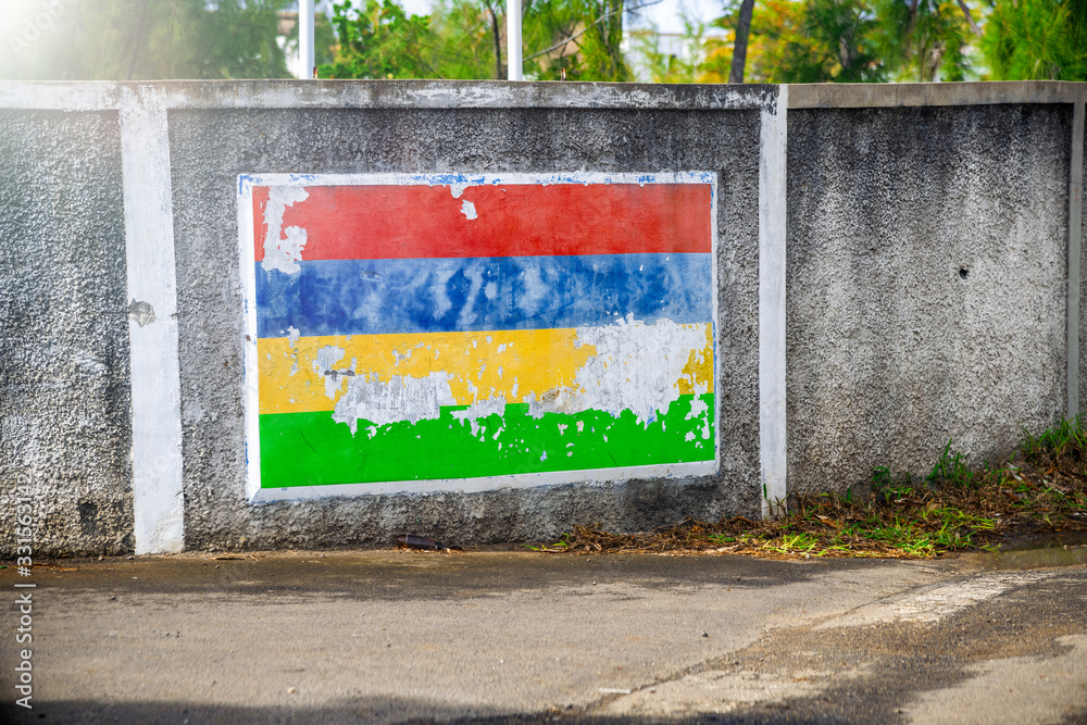 Obraz premium Mauritius flag pictured on a city wall. Travel and holiday concept