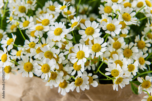 Fresh, lush bouquet of colorful flowers for present . Wedding bouquet of chamomile flowers. Close-up, macro © Georgiy