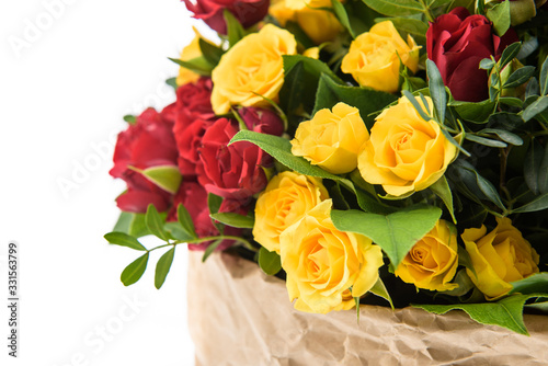 Fresh  lush bouquet of colorful flowers for present . Wedding bouquet of red and yellow roses and freesia flowers. Macro  close-up