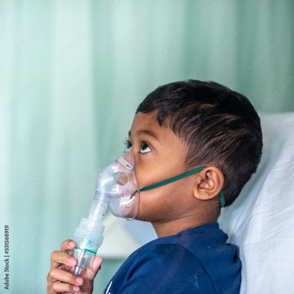 Muslim Boy with his nebuliser. Asthma treatment. Soft focus, shallow depth of field Muslim Boy with his nebuliser. Asthma treatment. Soft focus, shallow depth of field