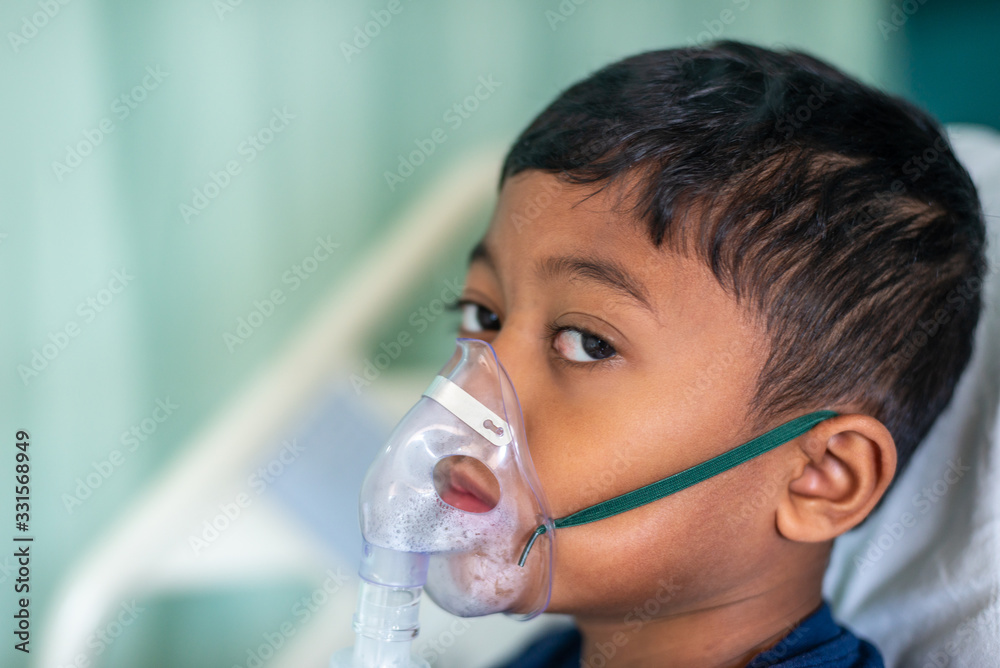 Muslim Boy with his nebuliser. Asthma treatment. Soft focus, shallow depth of field