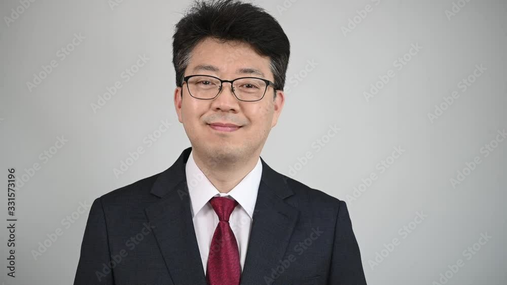 Asian male businessman looking at the front and smiling. Asian male businessman looking at the front and smiling.