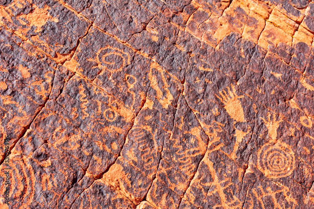 Ancient petroglyphs carved on sandstone rock in American Southwest desert Ancient petroglyphs carved on sandstone rock in American Southwest desert