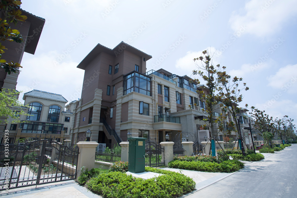 Townhouses under blue sky and white clouds