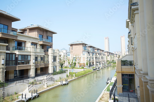 Townhouses under blue sky and white clouds