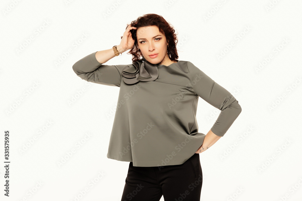 Confident business woman posing, looking at camera and holds her hand to her forehead over white background. Business concept. Mock up copy space. Confident business woman posing, looking at camera and holds her hand to her forehead over white background. Business concept. Mock up copy space.