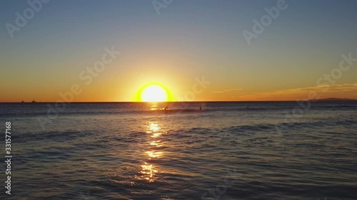 Golden Sunset Over Malibu Surfers In Ocean photo