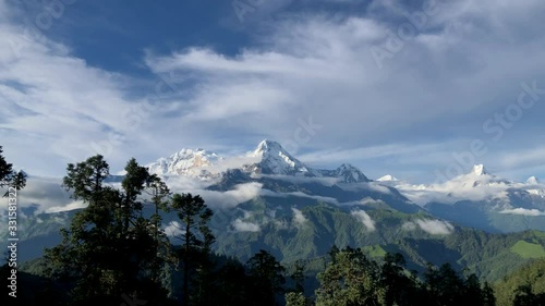 Timelapse of Annapurna South and the range with moving clouds. Wide Shot from Mohare Danda, Myagdi, Central Nepal. photo