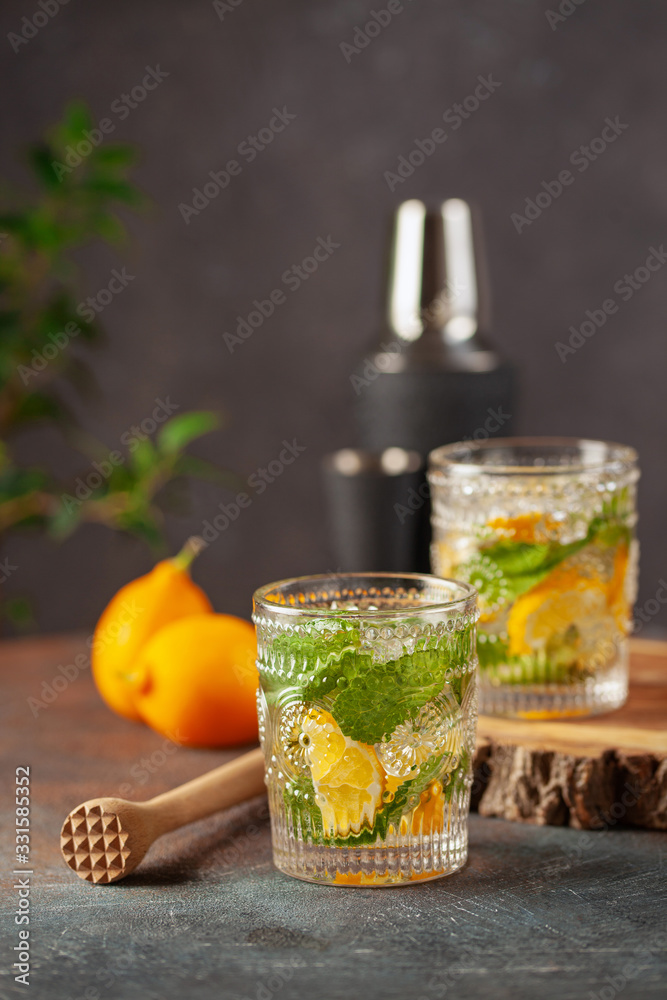 Lemonade or mojito cocktail with lemon and mint, cold refreshing drink or beverage with ice Lemonade or mojito cocktail with lemon and mint, cold refreshing drink or beverage with ice