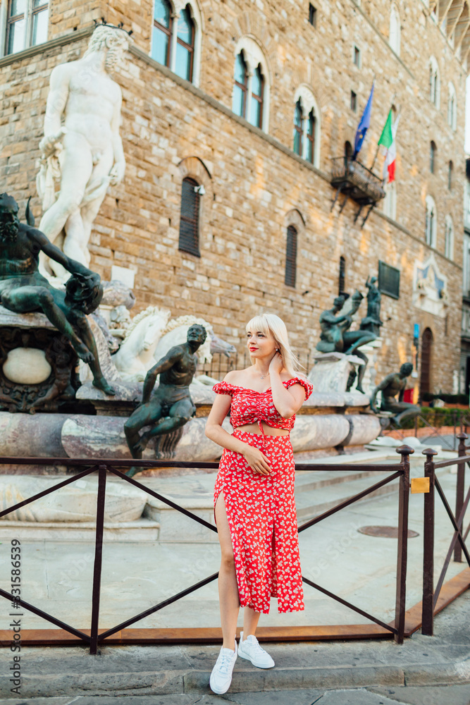 Woman standing at Florence Piazza della Signoria.