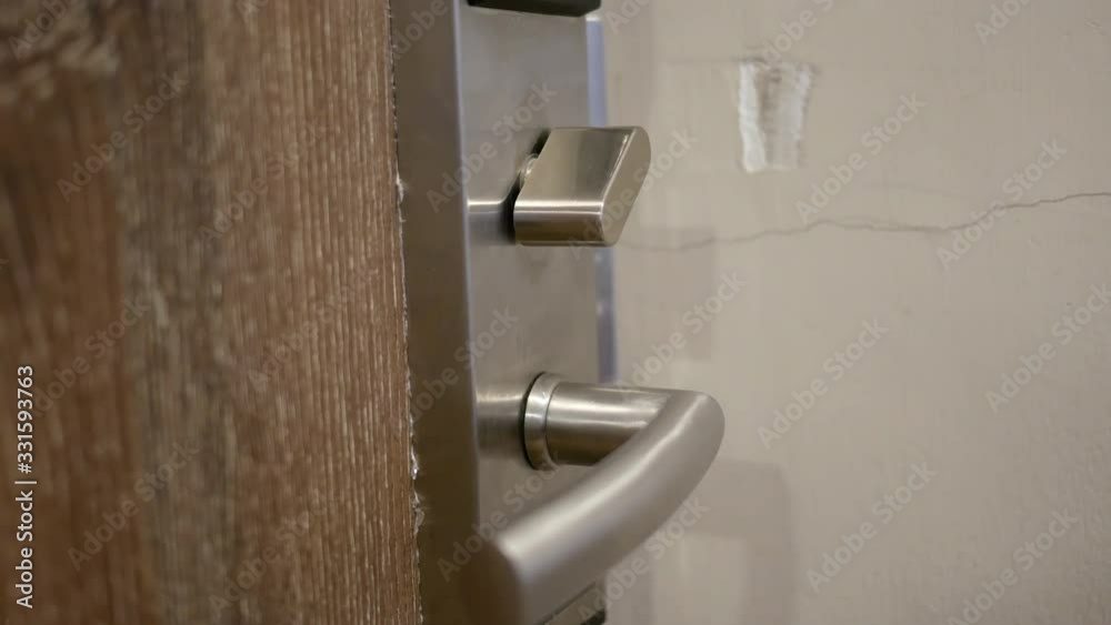 Close-up of female hand open lock or lock of door in the room. Close-up of female hand open lock or lock of door in the room.