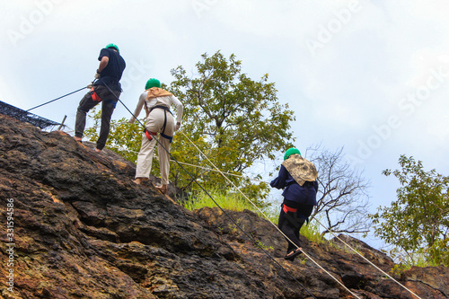 Men and women rock climbing