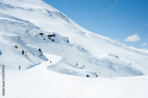 quiet ski slope with blue sky in the Austrian Mountains.