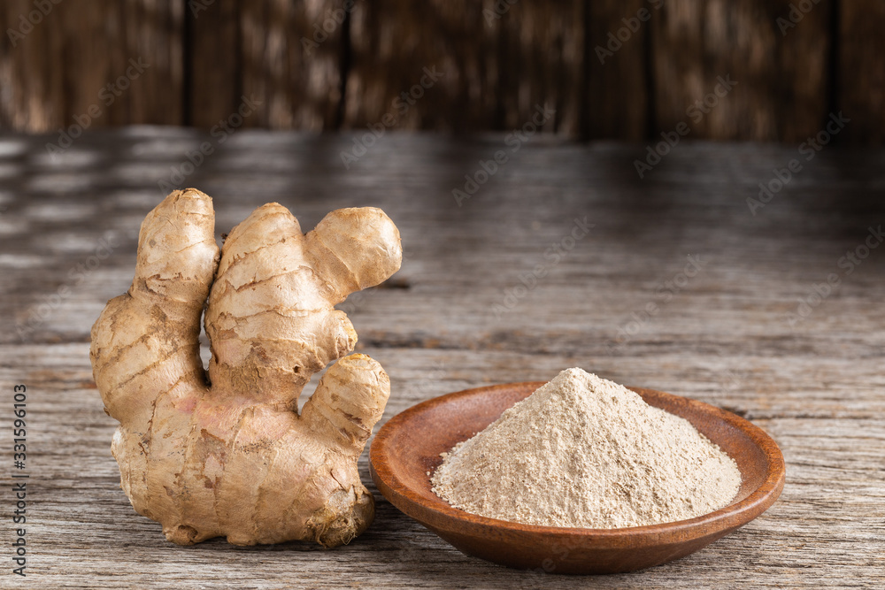 Powder and ginger root on the table, close-up Powder and ginger root on the table, close-up