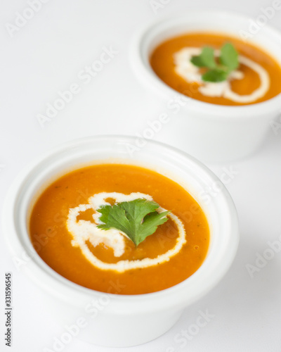 two bowls of carrot soup