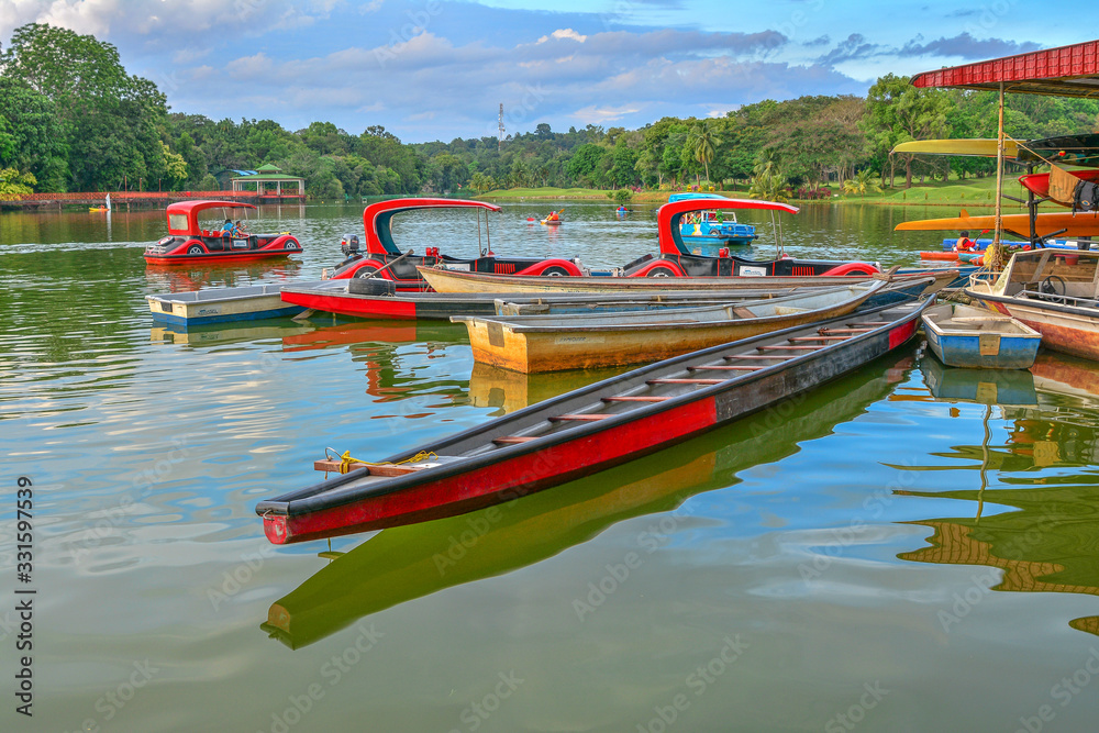 Fototapeta premium MALACCA, MALAYSIA : 12 Feb 2016 - Boat on the lake with green nature background at Ayer Keroh Lake, Malacca, Malaysia.