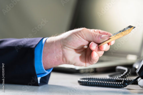 Male hand handing credit cards at an office